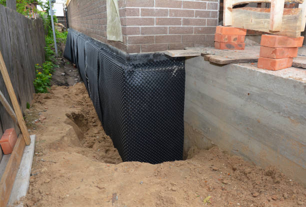 Happy homeowners after waterproofing job in Taylor